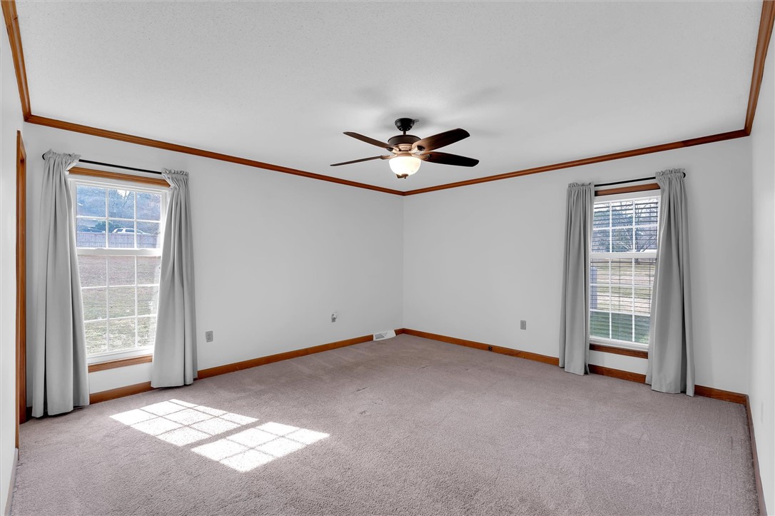 2114 Karen Lane Anderson, SC 29626 - Photo 17 of 30 This spacious bedroom offers ample natural light and a comfortable atmosphere for rest and relaxation.