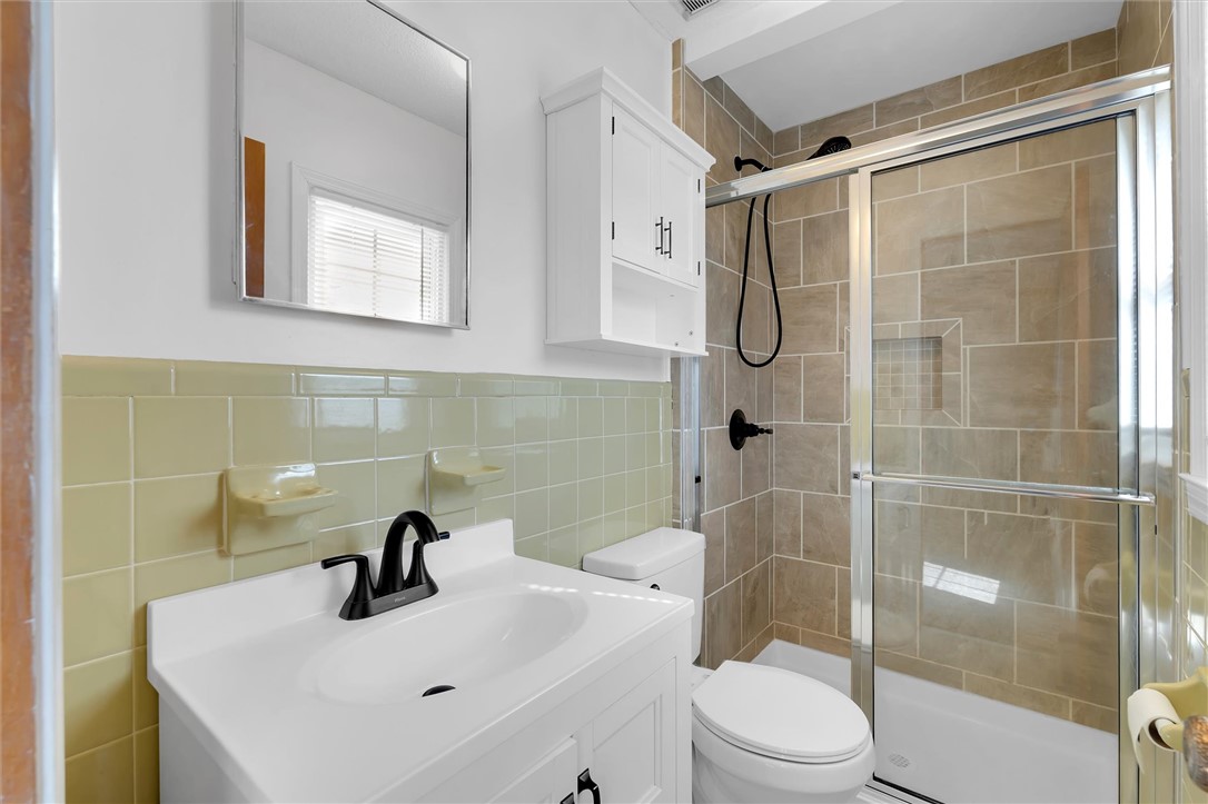 2114 Karen Lane Anderson, SC 29626 - Photo 19 of 30 This bright bathroom features sleek tiling and a contemporary vanity, offering both style and functionality.