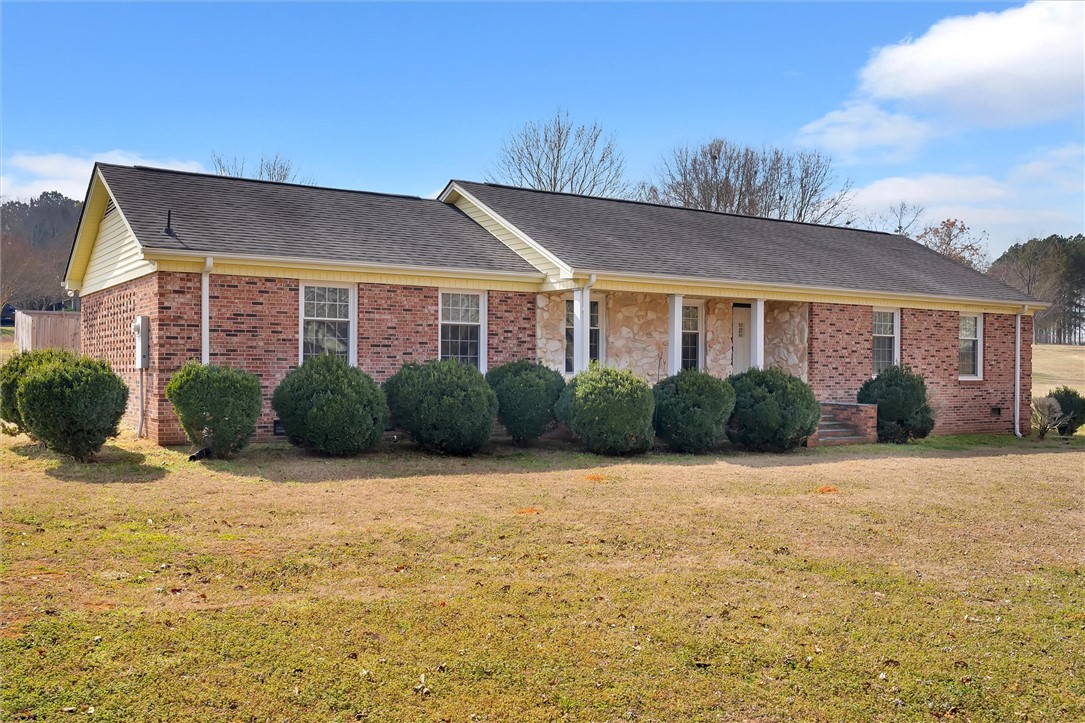2114 Karen Lane Anderson, SC 29626 - Photo 2 of 30 This ranch-style home features classic brick and stone construction with a well-maintained lawn.