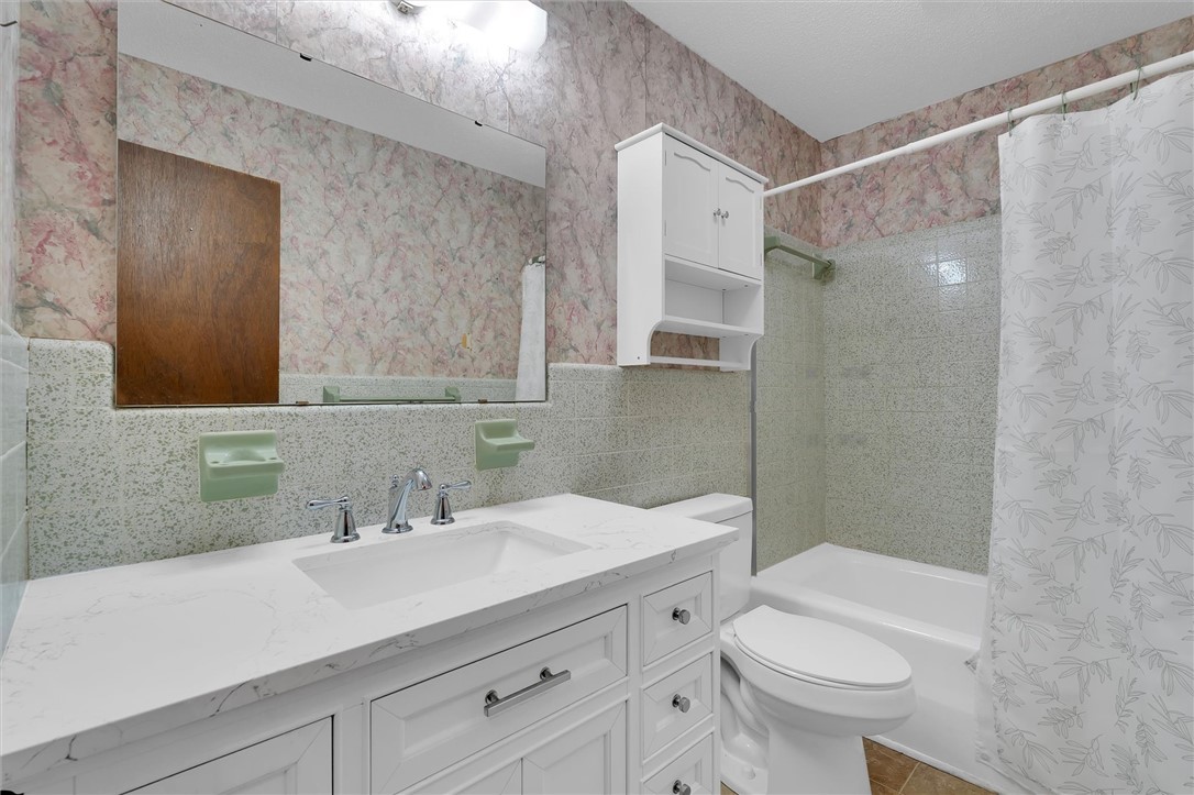 2114 Karen Lane Anderson, SC 29626 - Photo 21 of 30 This functional bathroom features a single vanity, a toilet, and a bathtub with a shower.