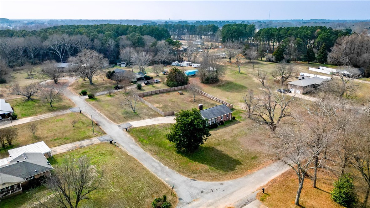 2114 Karen Lane Anderson, SC 29626 - Photo 30 of 30 This expansive aerial view showcases a residential property nestled within a wooded, open landscape.