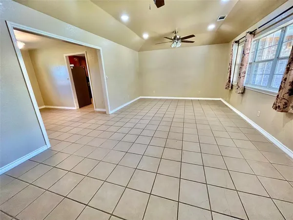a spacious bathroom with a tub sink and a mirror