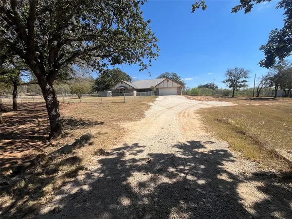 a view of a yard covered with snow on the road
