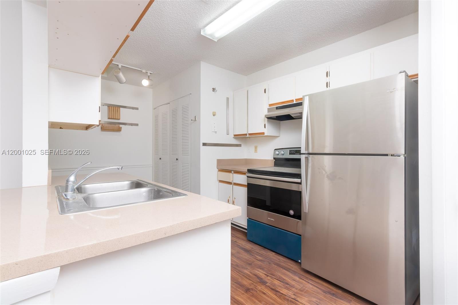 18310 Northwest 68th Avenue, Unit L Hialeah, FL 33015 - Photo 1 of 21 a kitchen with stainless steel appliances a refrigerator sink and microwave