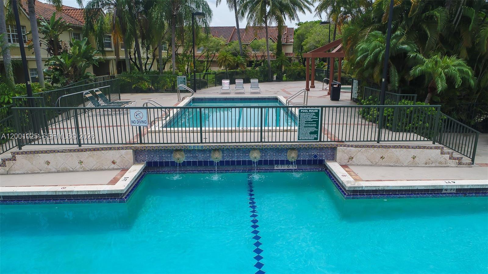 18310 Northwest 68th Avenue, Unit L Hialeah, FL 33015 - Photo 11 of 21 a view of a swimming pool with a garden