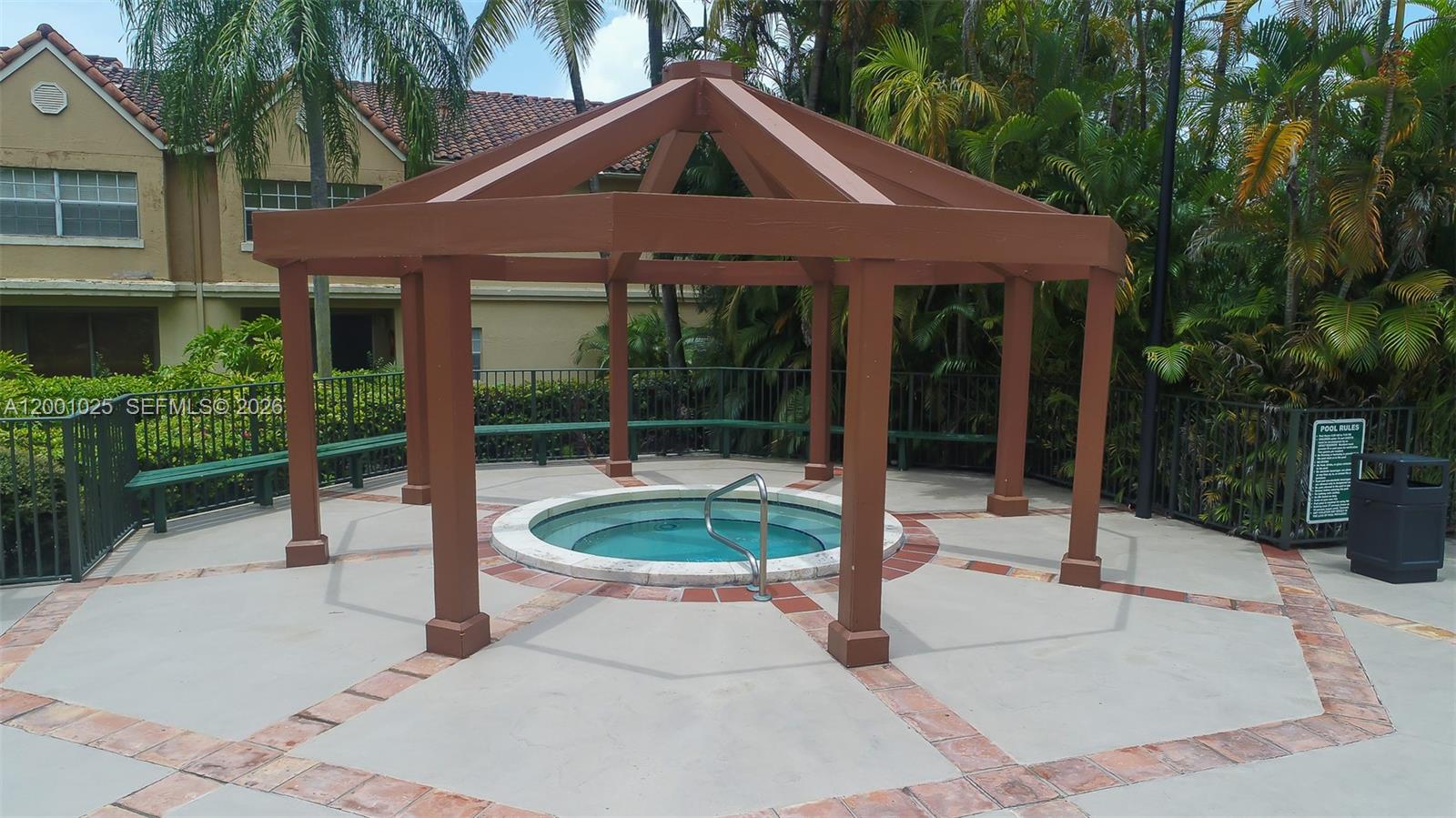 18310 Northwest 68th Avenue, Unit L Hialeah, FL 33015 - Photo 16 of 21 a patio with a yard table and chairs