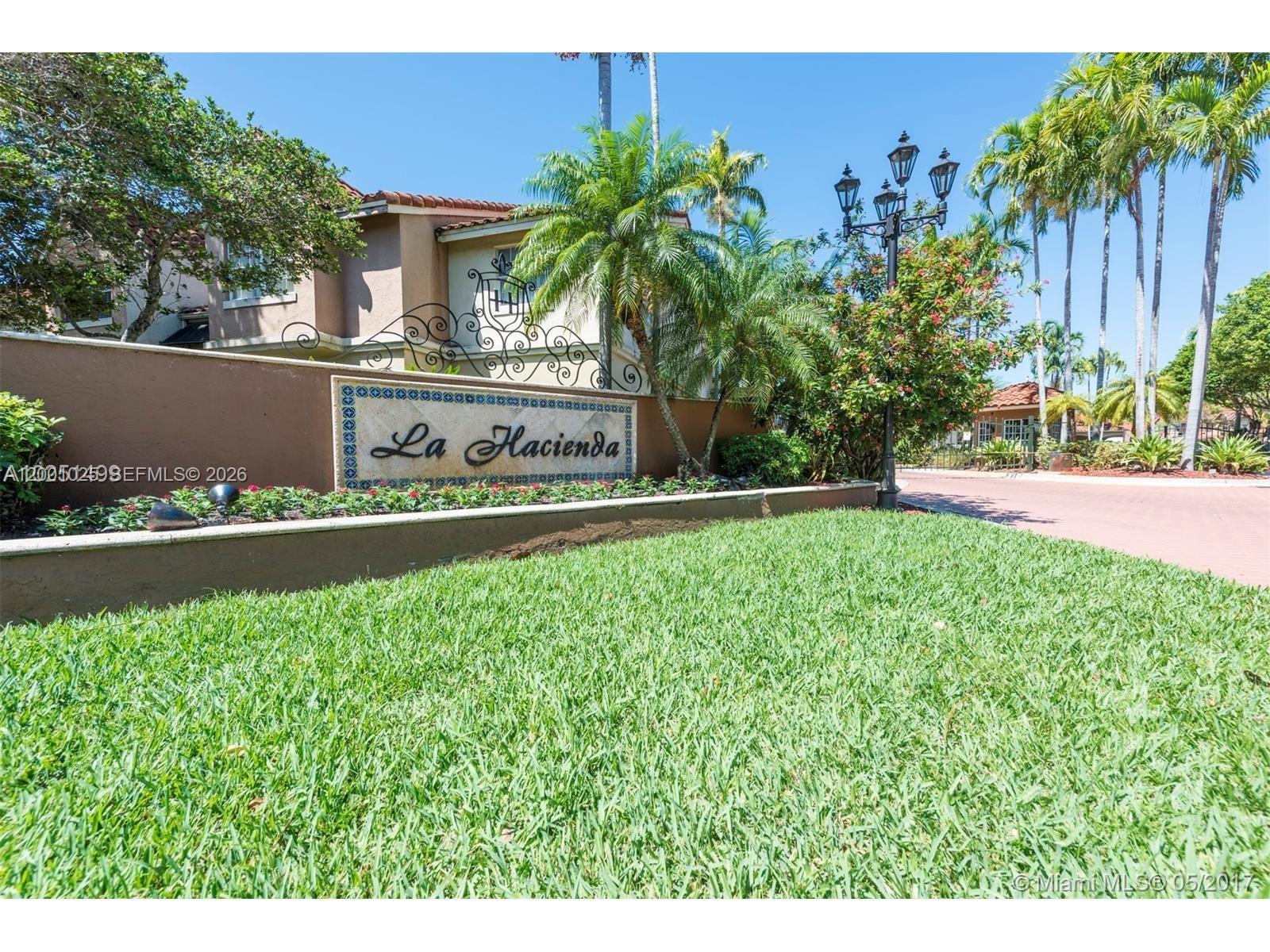 18310 Northwest 68th Avenue, Unit L Hialeah, FL 33015 - Photo 20 of 21 a front view of a house with garden