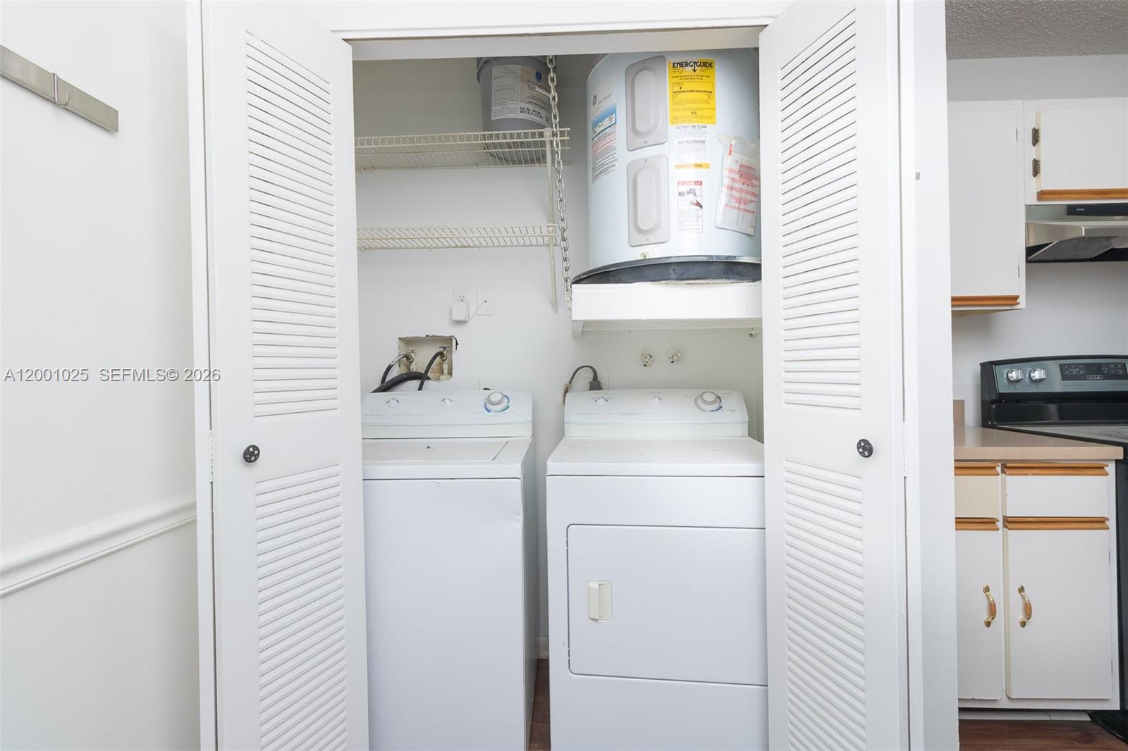 18310 Northwest 68th Avenue, Unit L Hialeah, FL 33015 - Photo 21 of 21 a bathroom with a sink a washer and dryer