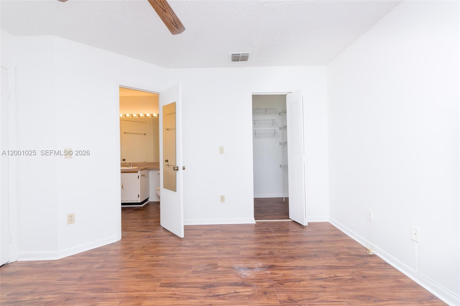18310 Northwest 68th Avenue, Unit L Hialeah, FL 33015 - Photo 5 of 21 a view of a room with wooden floor