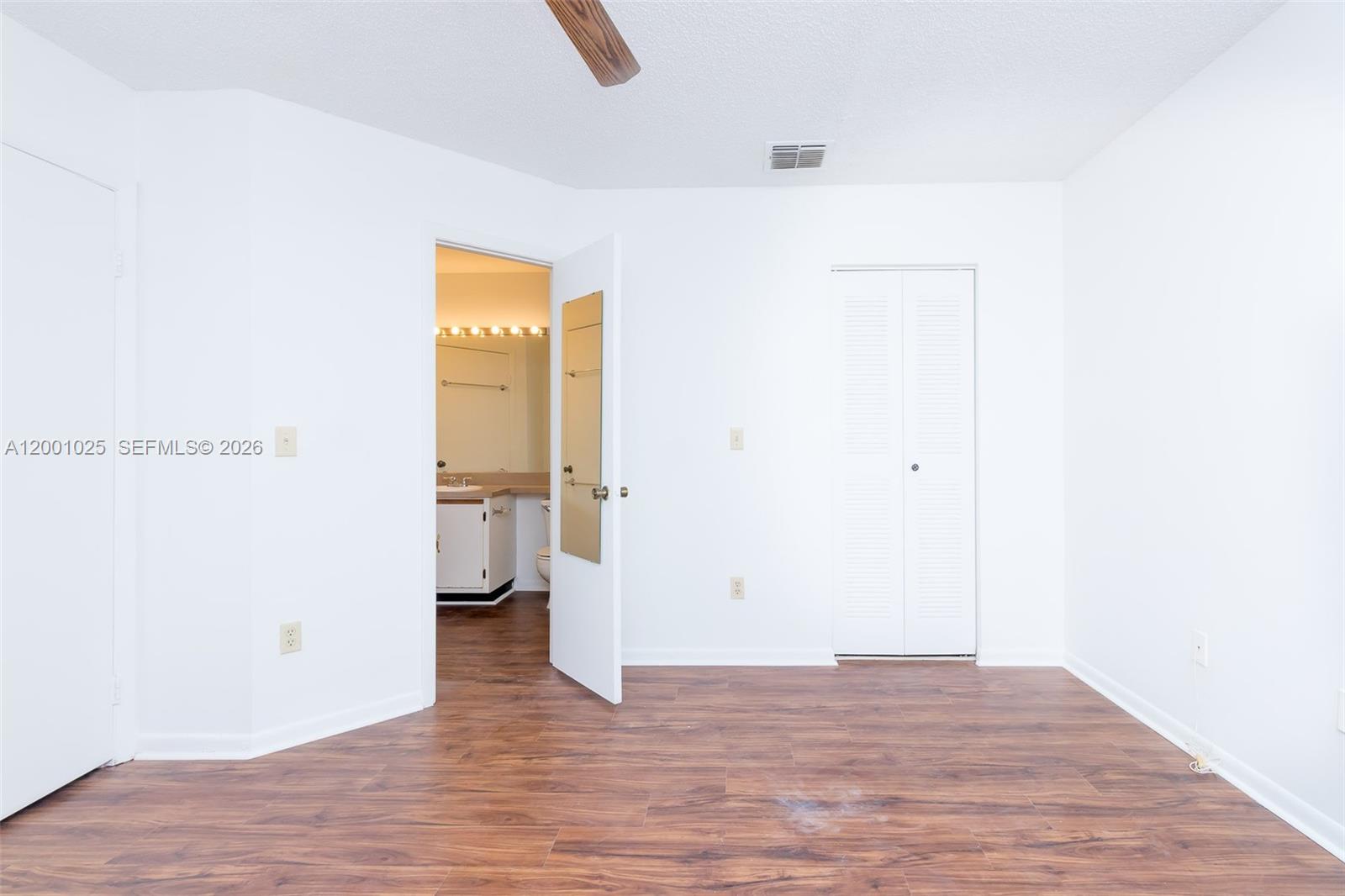 18310 Northwest 68th Avenue, Unit L Hialeah, FL 33015 - Photo 6 of 21 a view of empty room with wooden floor