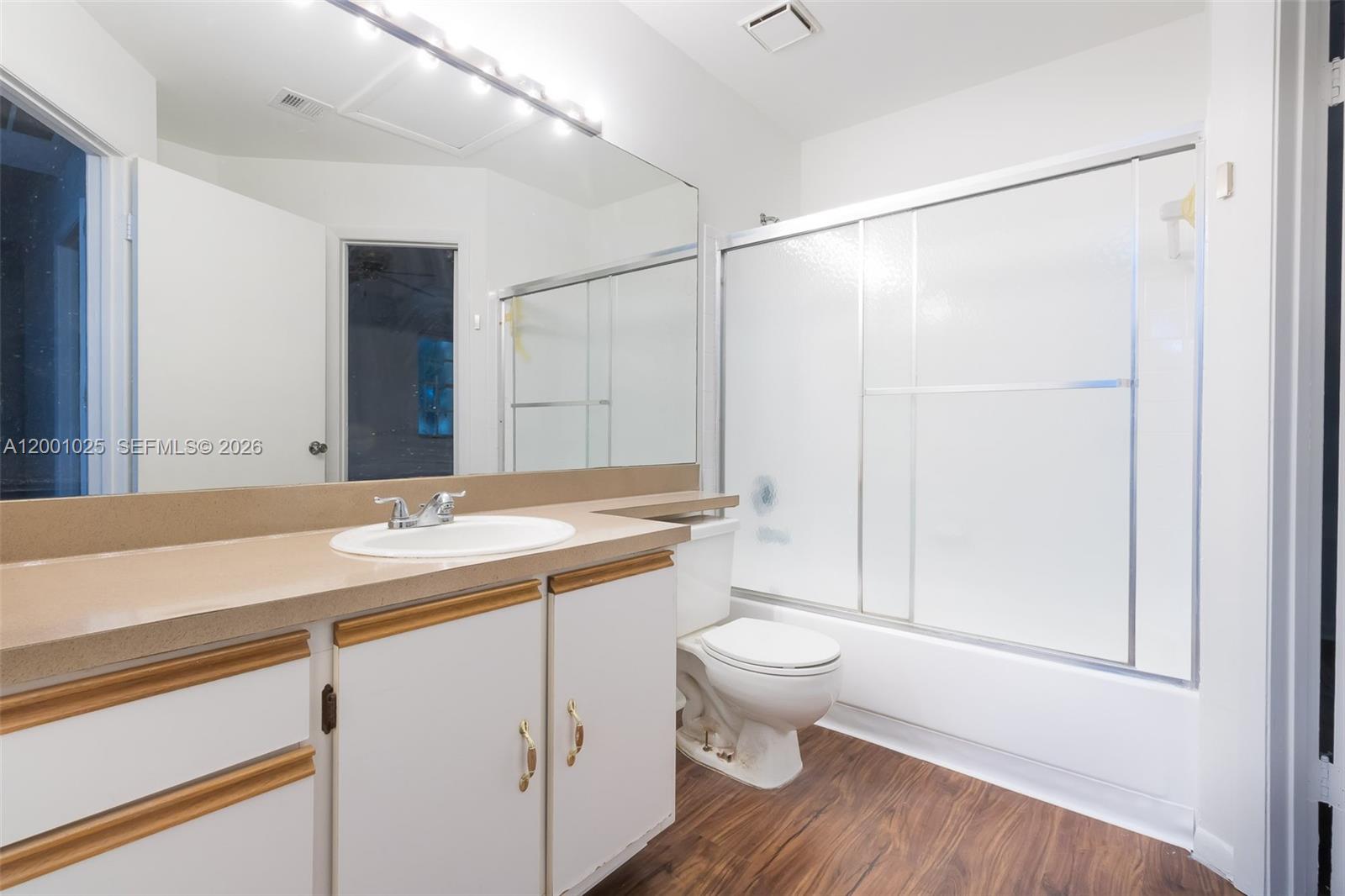 18310 Northwest 68th Avenue, Unit L Hialeah, FL 33015 - Photo 8 of 21 a bathroom with a granite countertop sink toilet and shower