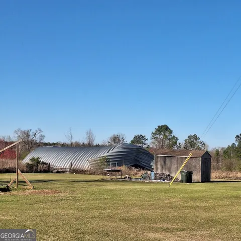 a view of a lake with beach and green space