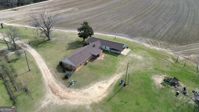a view of a backyard with plants and trees