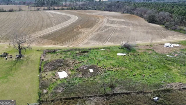an aerial view of residential house with outdoor space and trees