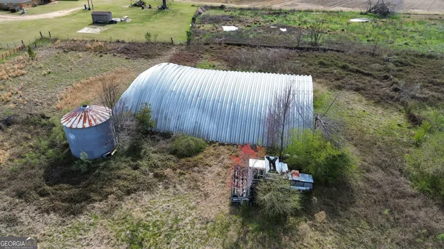 a view of a lake with a big yard and large trees
