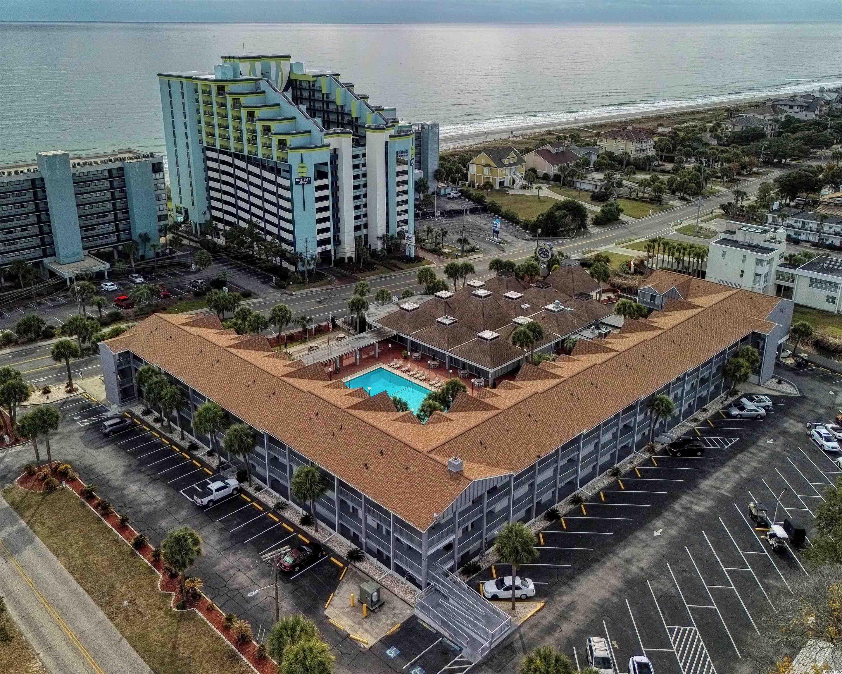Aerial view of unending shoreline and apartment complex / building