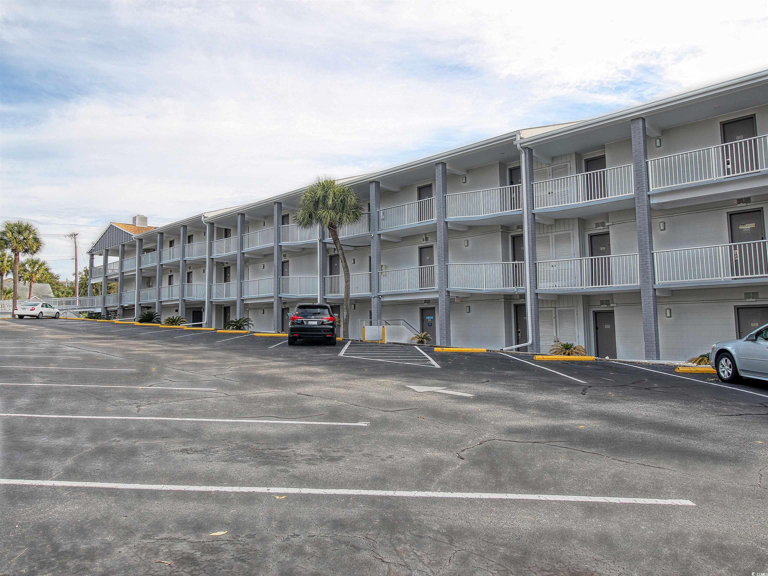 6803 North Ocean Boulevard, Unit 314 Myrtle Beach, SC 29572 - Photo 19 of 19 View of apartment building / complex featuring uncovered parking