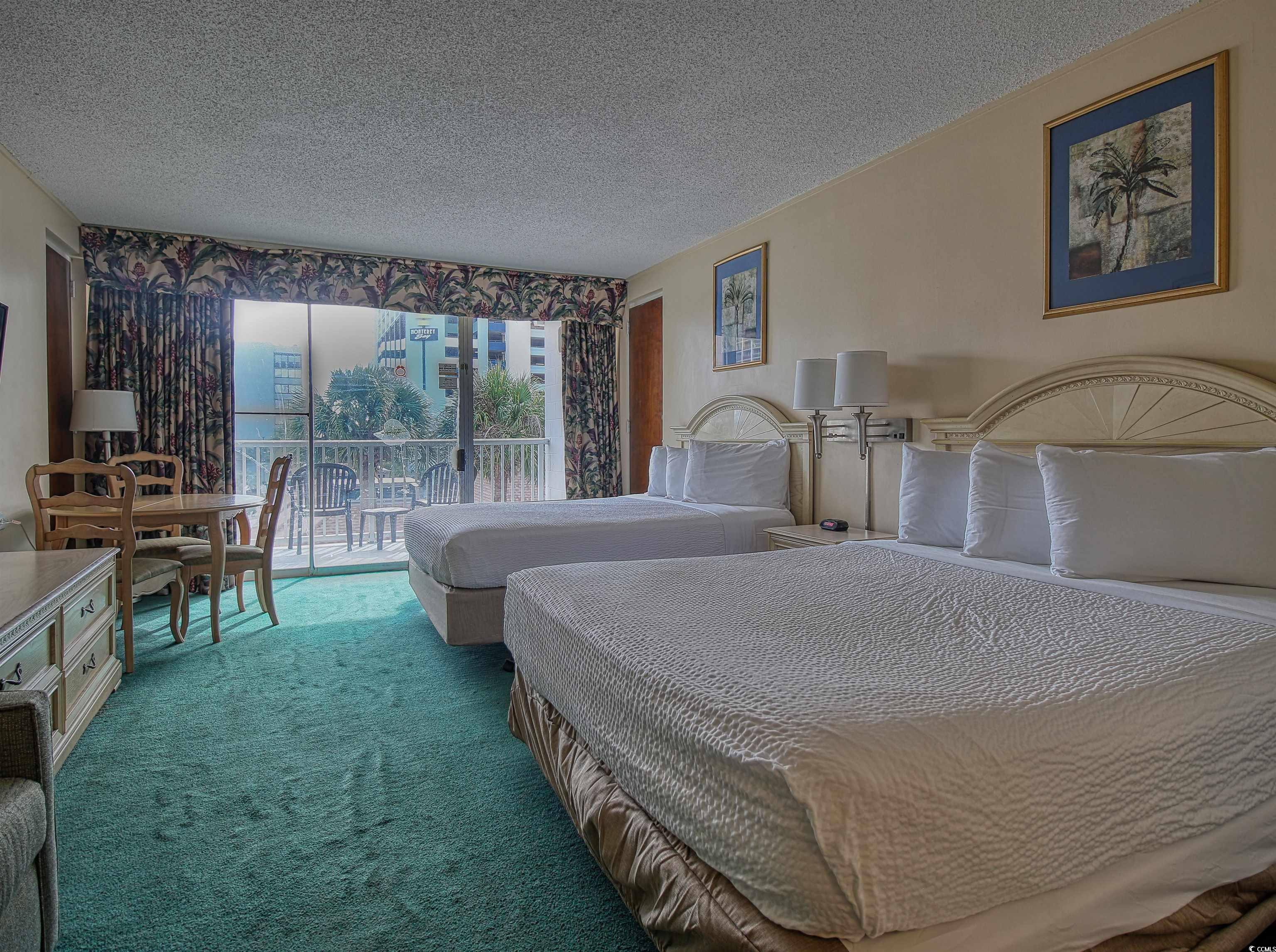 6803 North Ocean Boulevard, Unit 314 Myrtle Beach, SC 29572 - Photo 3 of 19 Carpeted bedroom with access to exterior and a textured ceiling