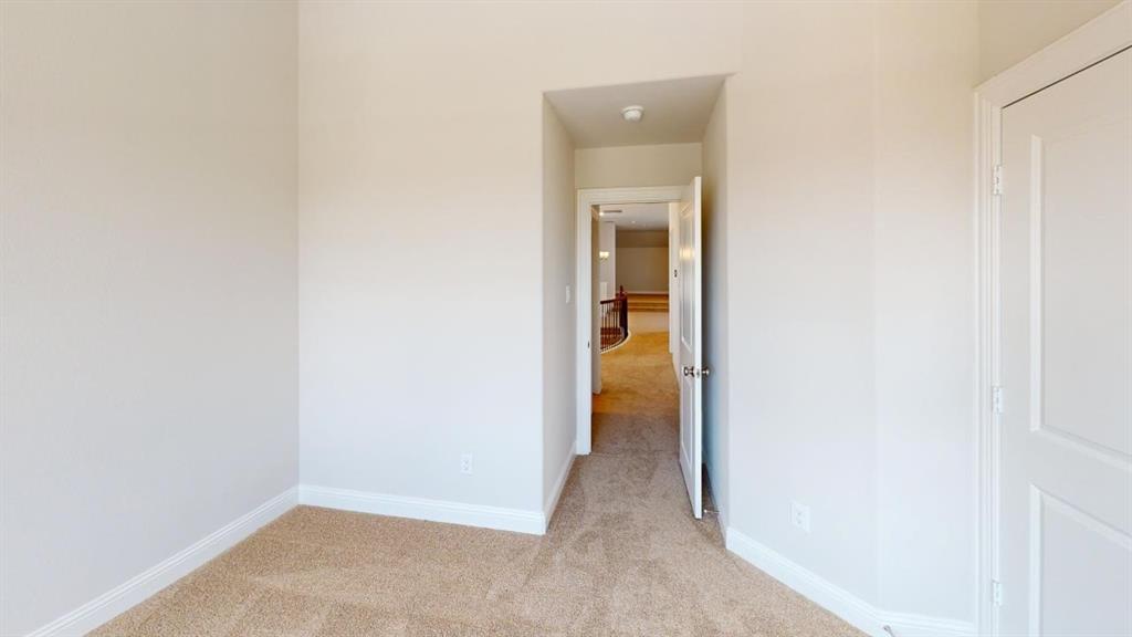 8407 Cornerstone Drive Rowlett, TX 75088 - Photo 10 of 25 Carpeted interior room featuring light wall tones, white trim, and a paneled door