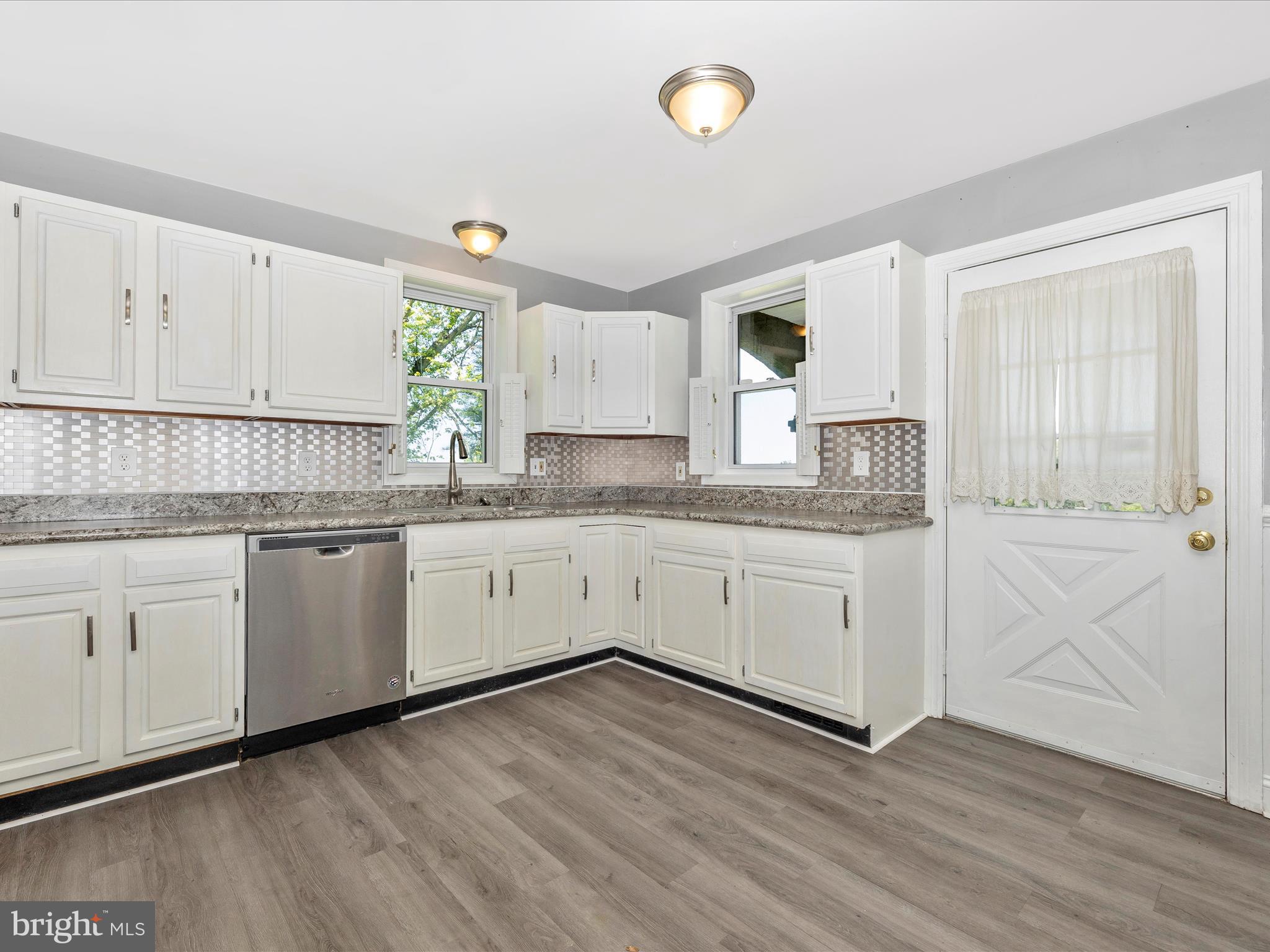 6330 Clevelandtown Road Boonsboro, MD 21713 - Photo 12 of 56 a kitchen with granite countertop white cabinets and white appliances with wooden floor