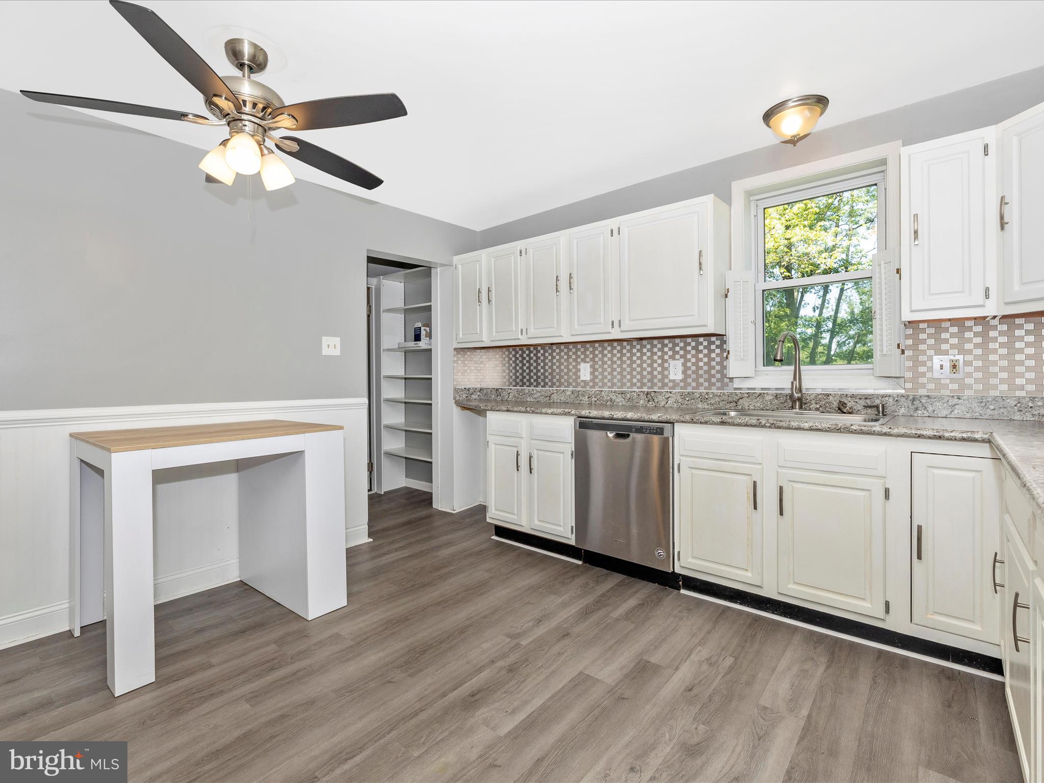 6330 Clevelandtown Road Boonsboro, MD 21713 - Photo 14 of 56 a kitchen with granite countertop white cabinets and white appliances