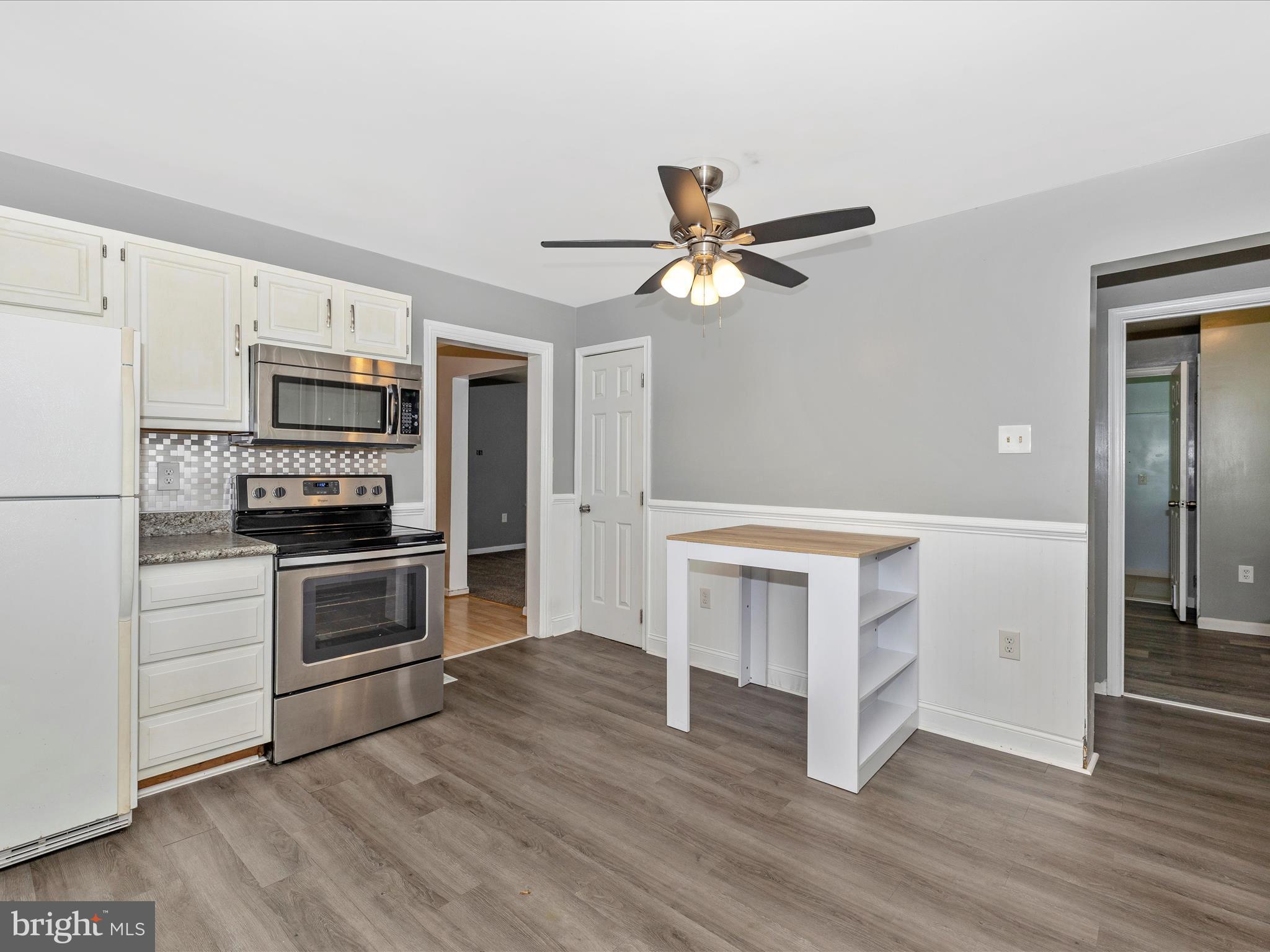 6330 Clevelandtown Road Boonsboro, MD 21713 - Photo 15 of 56 a kitchen with granite countertop white cabinets and stainless steel appliances