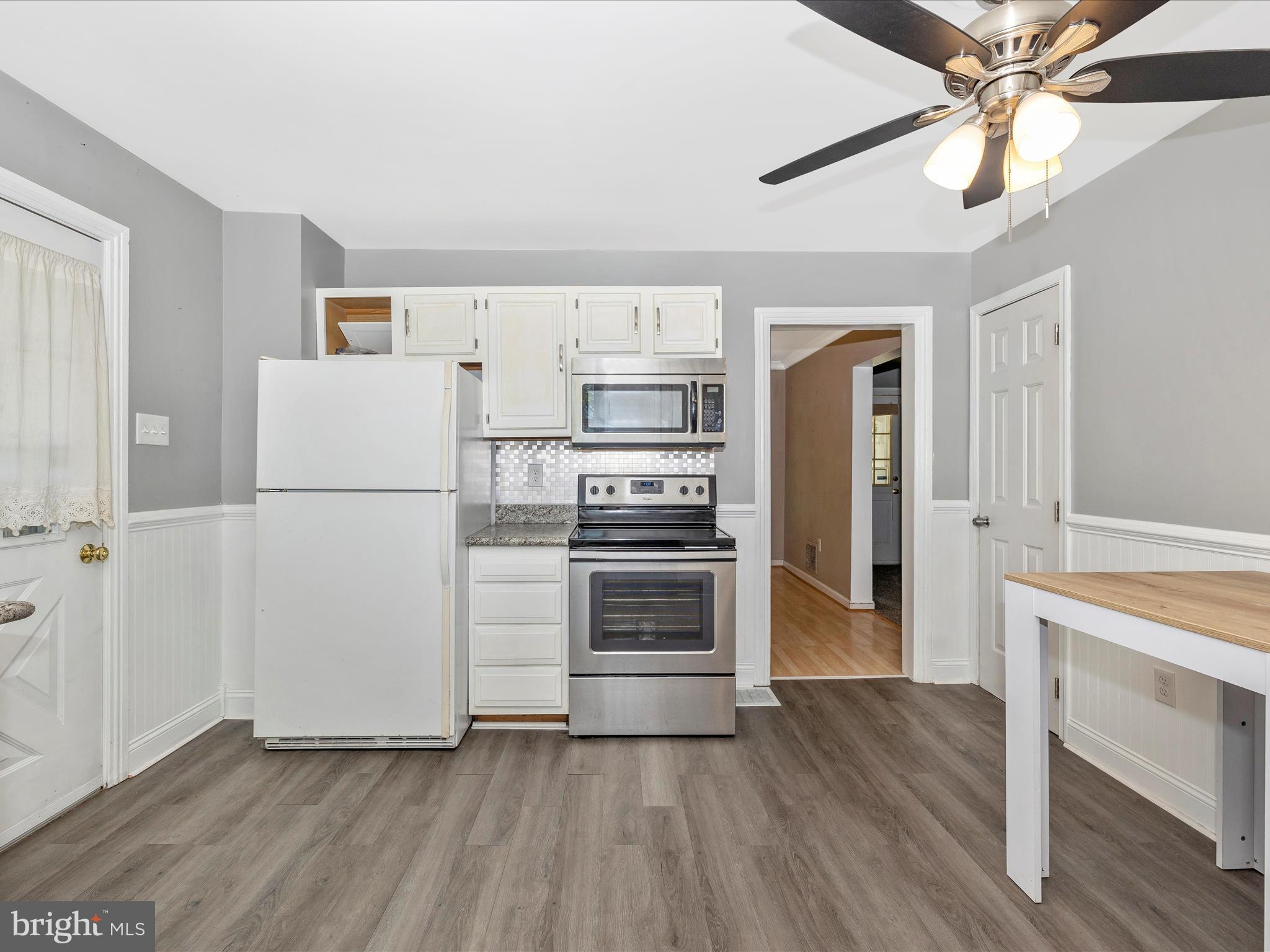 6330 Clevelandtown Road Boonsboro, MD 21713 - Photo 16 of 56 a kitchen with a refrigerator and a stove top oven