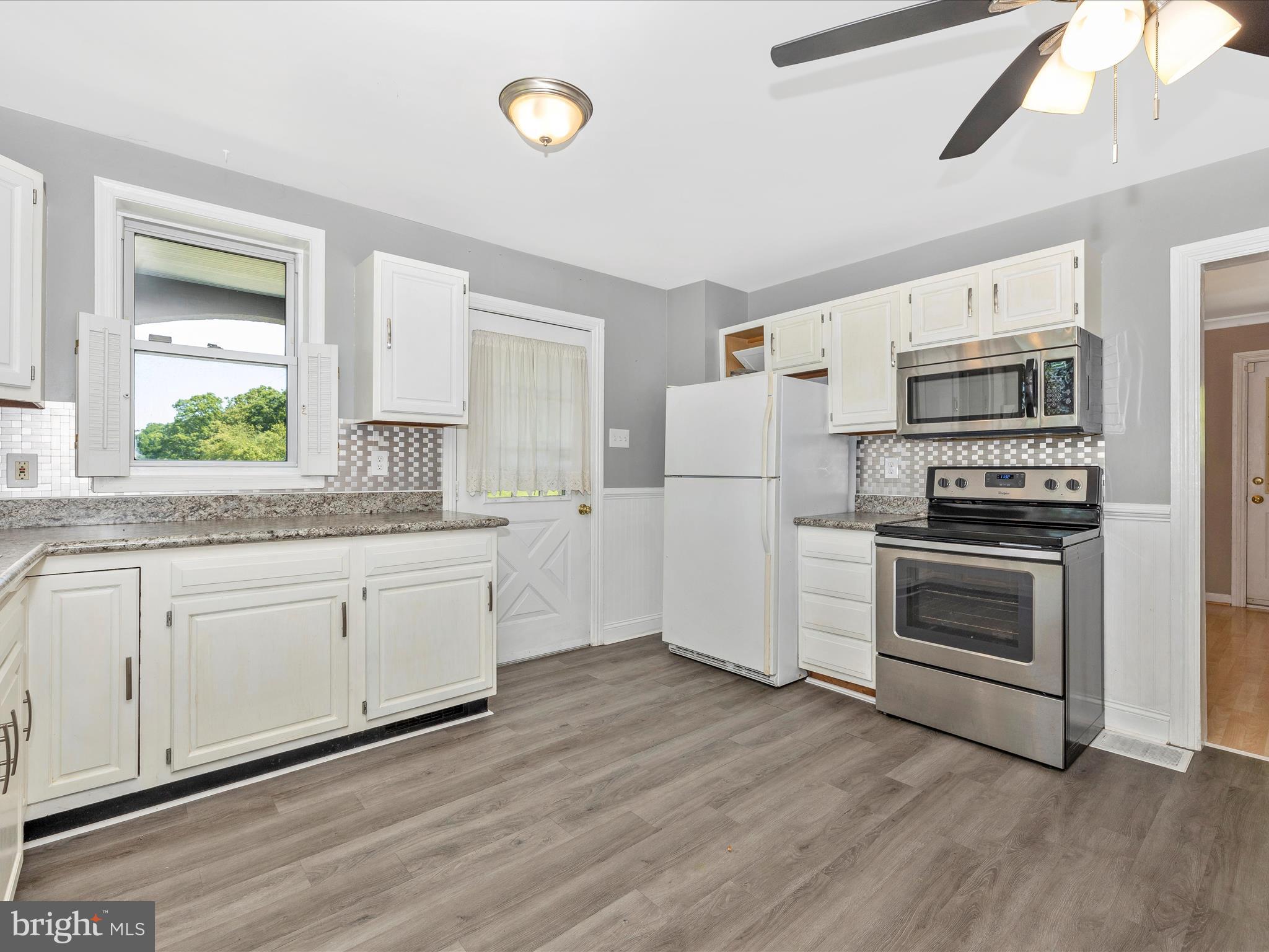 6330 Clevelandtown Road Boonsboro, MD 21713 - Photo 17 of 56 a kitchen with granite countertop white cabinets and white appliances