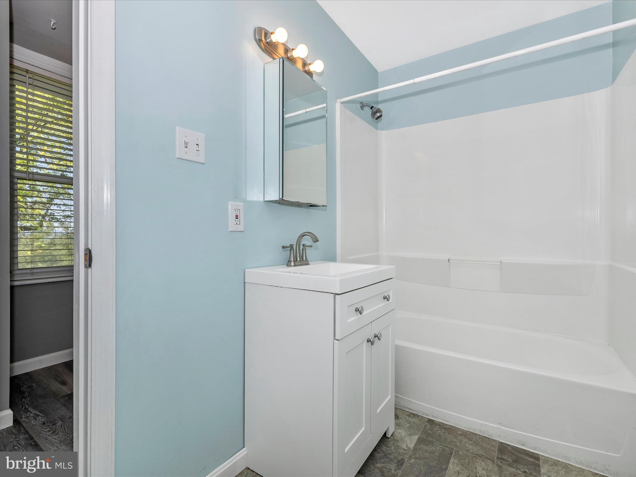 6330 Clevelandtown Road Boonsboro, MD 21713 - Photo 20 of 56 a bathroom with a sink mirror vanity and bathtub