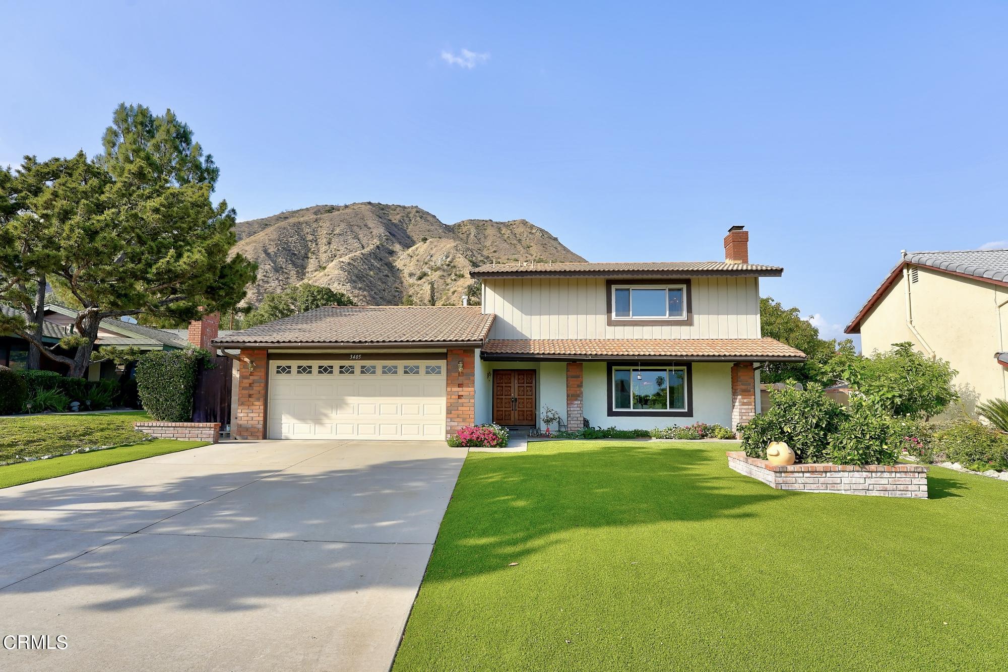 3405 Brookridge Road Duarte, CA 91010 - Photo 3 of 40 a front view of a house with a yard and potted plants