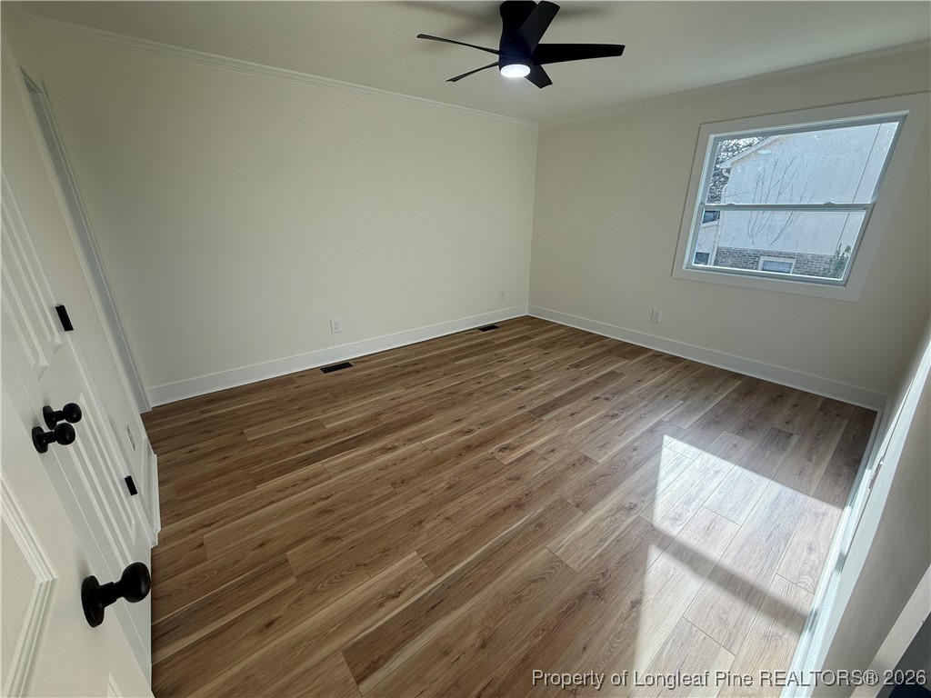 5508 Sweetbriar Drive Raleigh, NC 27609 - Photo 14 of 29 a view of empty room with wooden floor and fan