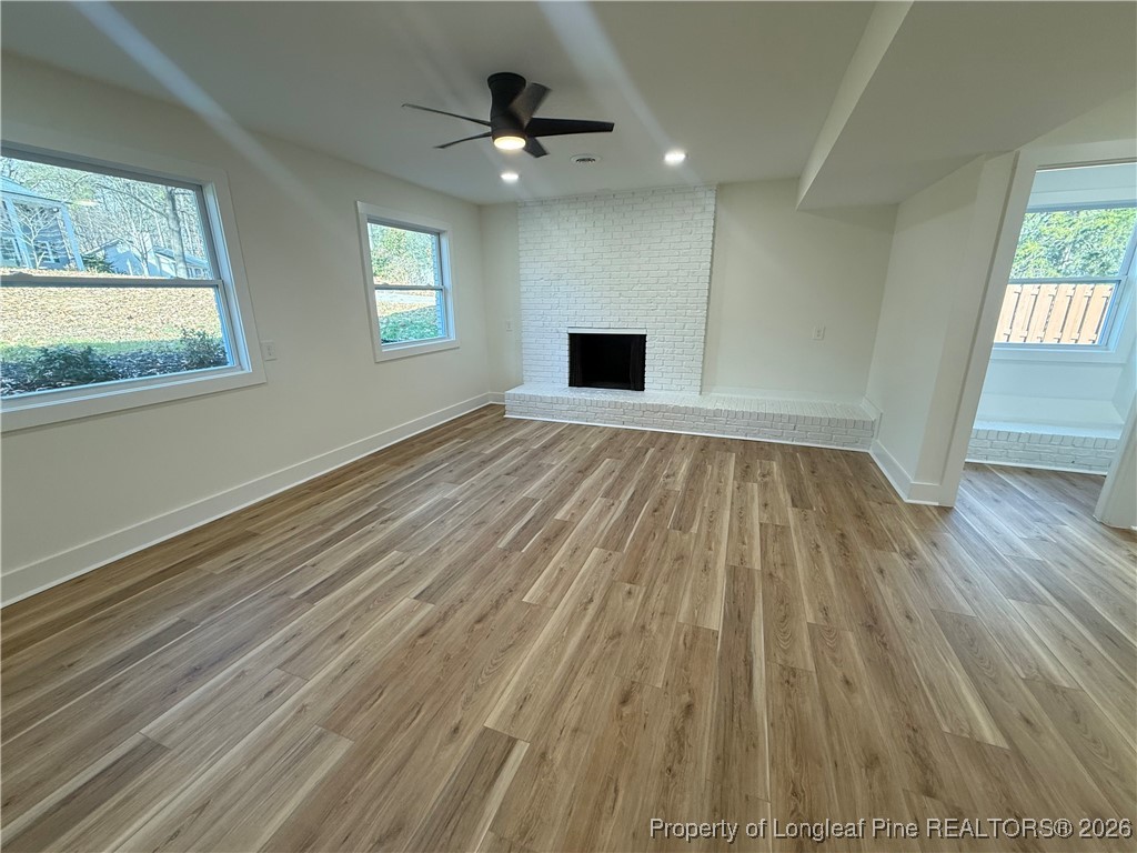 5508 Sweetbriar Drive Raleigh, NC 27609 - Photo 19 of 29 a view of an empty room with wooden floor and window