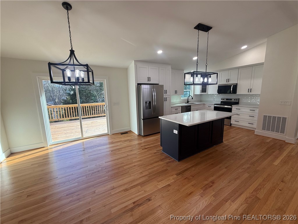 5508 Sweetbriar Drive Raleigh, NC 27609 - Photo 8 of 29 a large kitchen with stainless steel appliances granite countertop a refrigerator a sink dishwasher a oven and a wooden floor