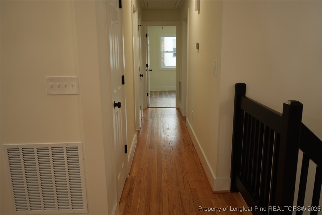 5508 Sweetbriar Drive Raleigh, NC 27609 - Photo 10 of 29 a view of a hallway with wooden floor