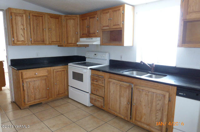 201 Mini Pines Road Yakima, WA 98903 - Photo 8 of 11 a kitchen with stainless steel appliances granite countertop a sink stove and cabinets