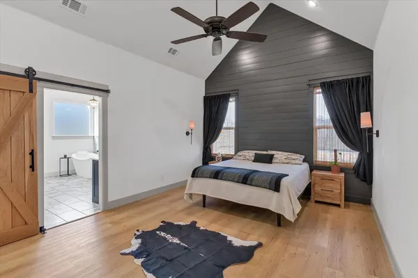 a bedroom with furniture and a wooden floor