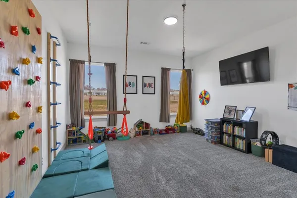 a bedroom with furniture and a flat screen tv
