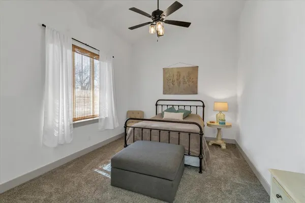 a bedroom with a bed and window