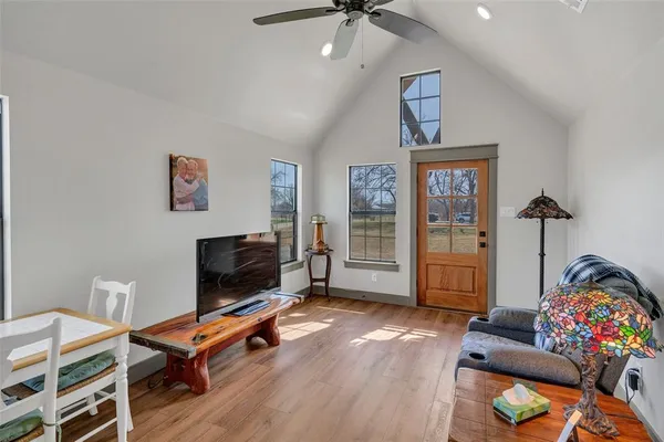 a living room with furniture a flat screen tv and a window