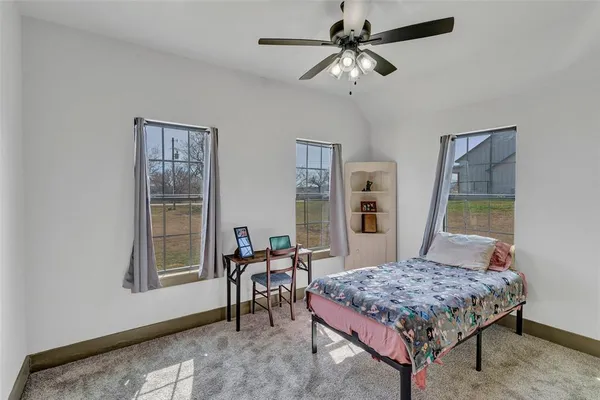 a bedroom with a bed a table and chair