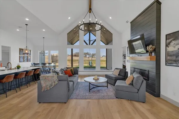 a living room with fireplace furniture and a large window
