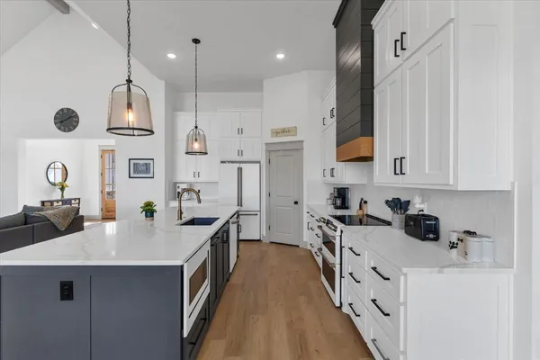a kitchen with stainless steel appliances a sink stove and refrigerator