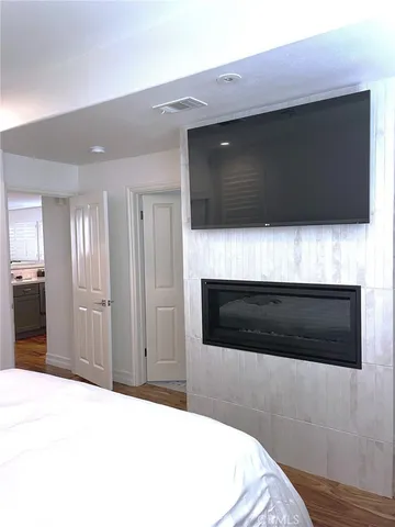 a living room with a fireplace and a flat screen tv