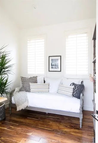 a bedroom with a bed and a potted plant