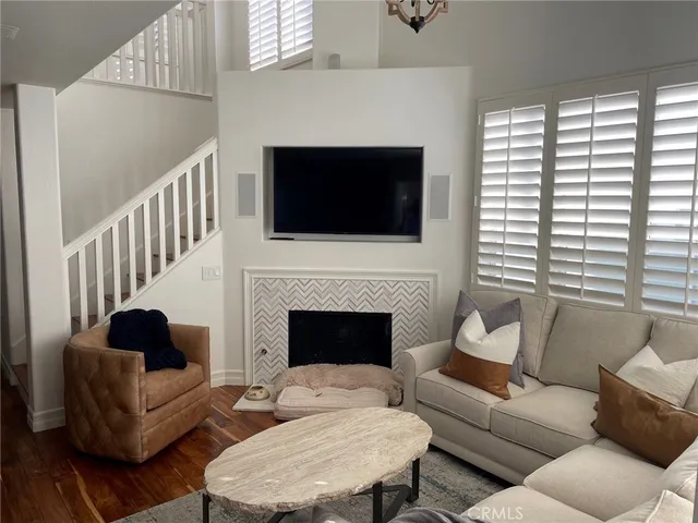 a living room with furniture a fireplace and a flat screen tv
