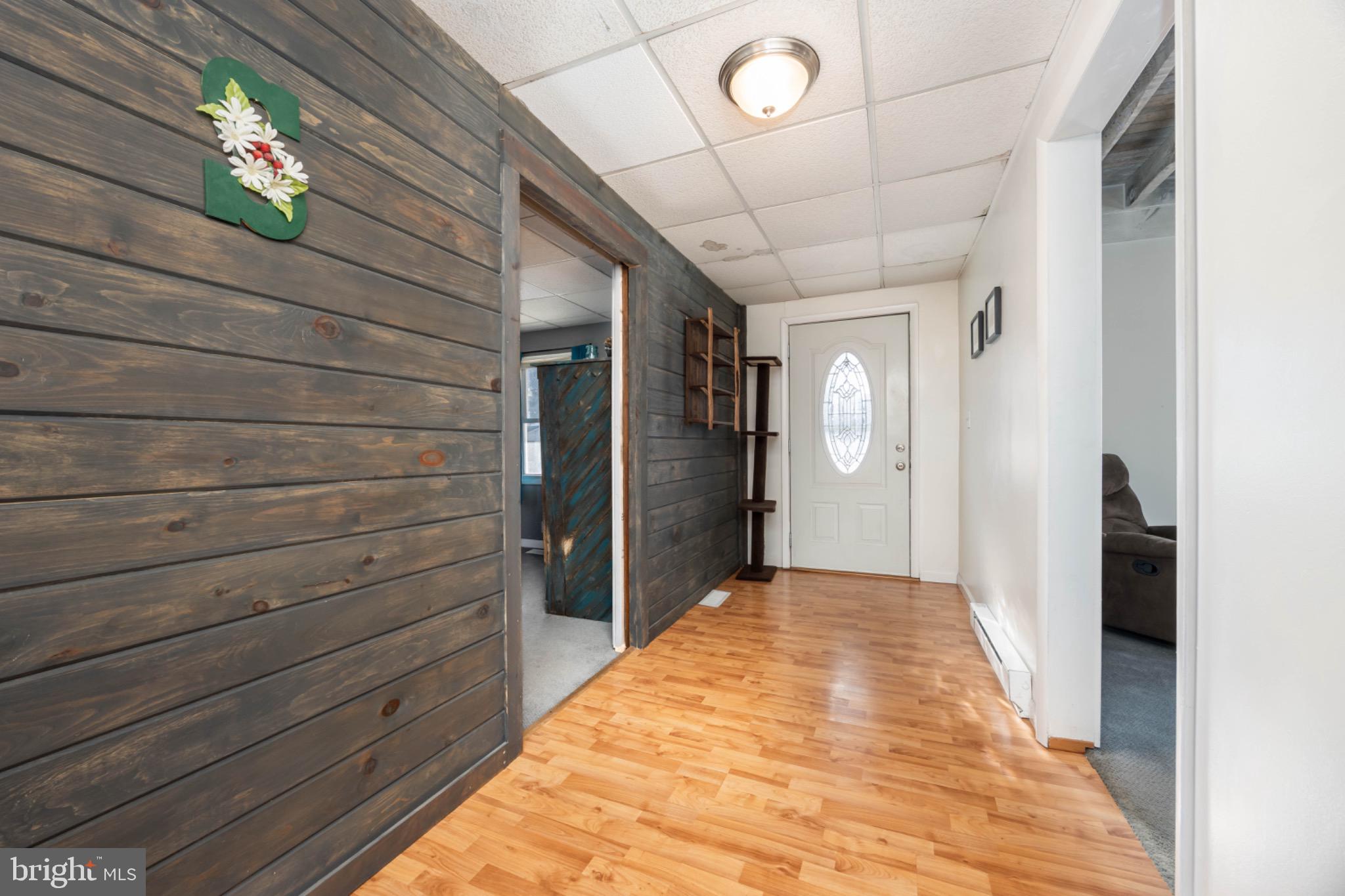 505 Main Street Mardela Springs, MD 21837 - Photo 15 of 60 a view of a hallway with wooden floor and a chandelier