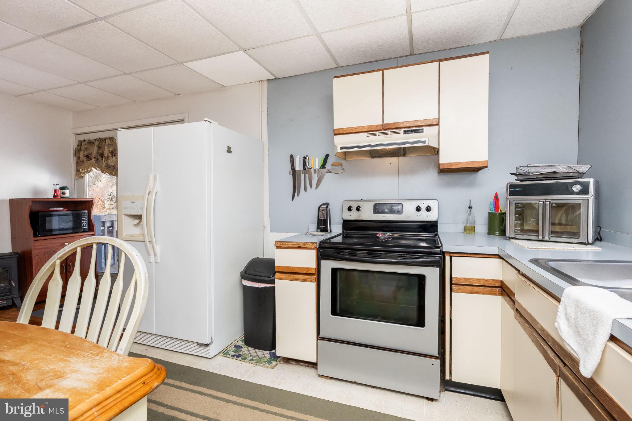 505 Main Street Mardela Springs, MD 21837 - Photo 19 of 60 a kitchen with stainless steel appliances granite countertop a stove a sink and a refrigerator