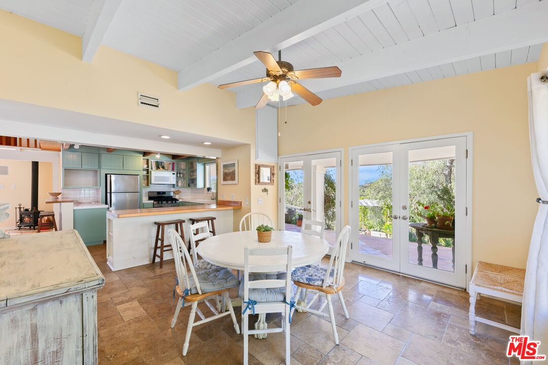 2302 Latigo Canyon Road Malibu, CA 90265 - Photo 13 of 30 a dining room with furniture a chandelier and wooden floor