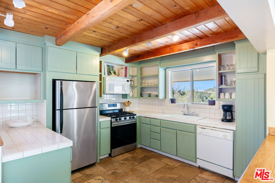 2302 Latigo Canyon Road Malibu, CA 90265 - Photo 15 of 30 a kitchen with a sink stainless steel appliances and cabinets