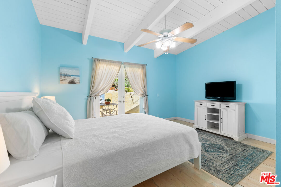 2302 Latigo Canyon Road Malibu, CA 90265 - Photo 16 of 30 a bedroom with a bed and a flat screen tv